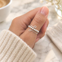 Main qui fait tourner les perles d'une bague anti-stress